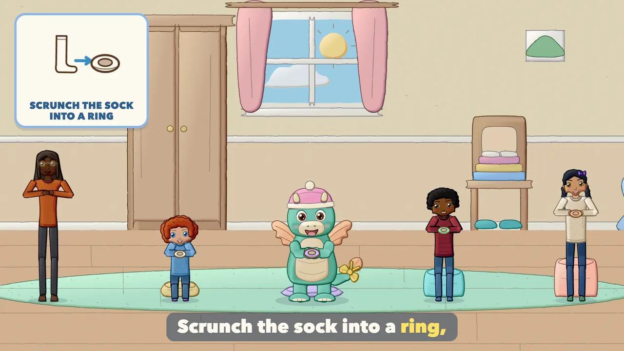 Children holding a scrunched sock ring over a raised foot.